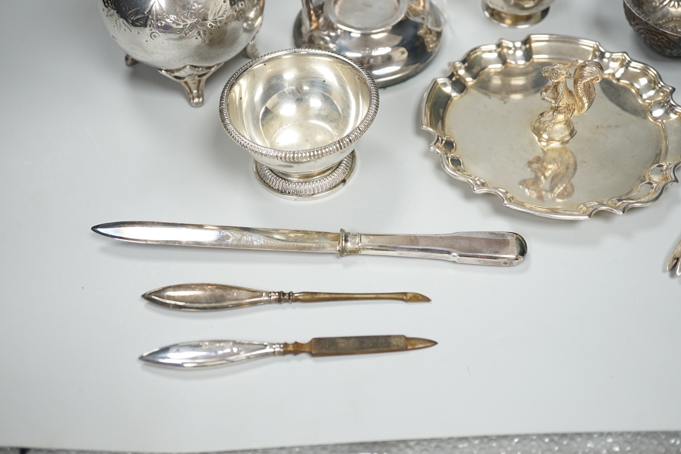 A 1920's silver mounted manicure stand with mirror and three associated implements, a small silver two handled salt, modern silver bowl, continental repousse white metal bowl, boxed modern silver letter opener and four p